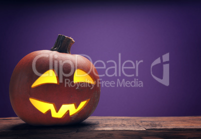 Carved halloween pumpkin Jack o lantern on a rustic wooden table