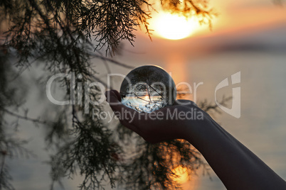 Beautiful sunset through a transparent glass ball