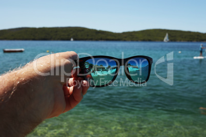 Sunglasses on the background of the sea on a sunny day