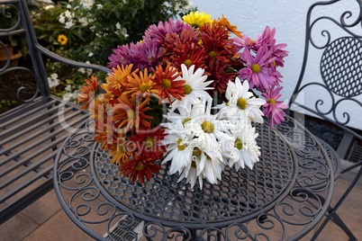 Beautiful multi-colored daisies stand on the table
