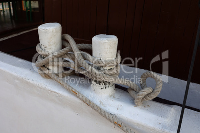 Bollard with a mooring line wrapped around it