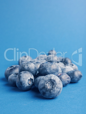 A heap of blueberries on a blue background