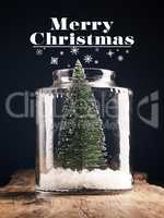 A Christmas tree in a jar with snow, Christmas greeting card