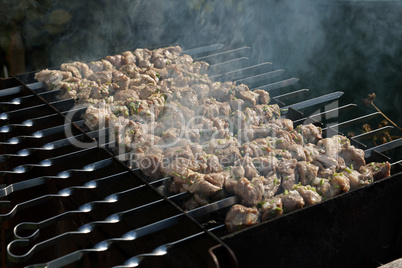Meat on skewers is fried on the grill