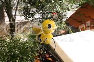 Decorative figure of a bee on the terrace near the house