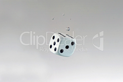 Dice falling into the water with splashes