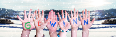 Children Hands Building Word Gewinn Means Prize, Snowy Winter Background