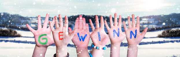 Children Hands Building Word Gewinn Means Prize, Snowy Winter Background