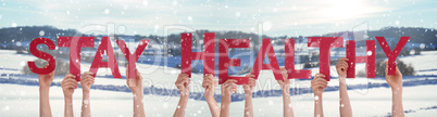 People Hands Holding Word Stay Healthy, Snowy Winter Background