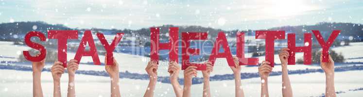 People Hands Holding Word Stay Healthy, Snowy Winter Background