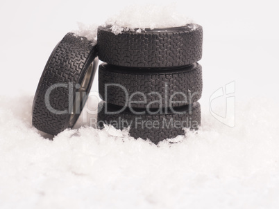 Winter tires stacked in the snow, winter season concept