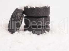 Winter tires stacked in the snow, winter season concept