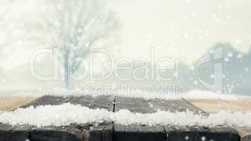 Rustic wooden table with snow and winter landscape