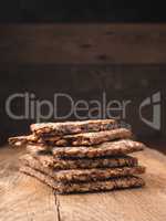 Stacked organic crispbread on a rustic wooden table