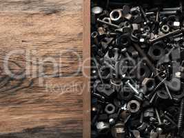 Rusty old bolts and nuts in a wooden box