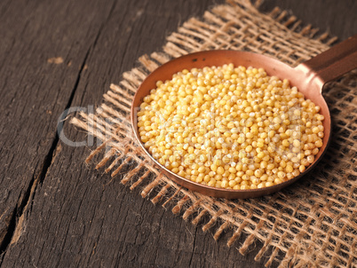 Copper bowl filled with hulled organic millet