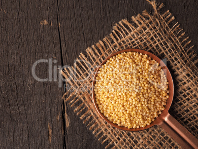 Copper bowl filled with hulled organic millet