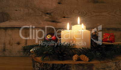 Third Advent candle burning, traditional Christmas decoration