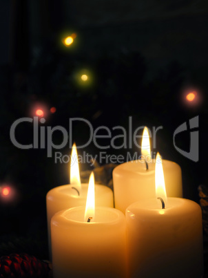 Close up of four burning Advent candles in a dark living room