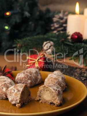 Delicious Christmas stollen on a ceramic plate in front of an Ad