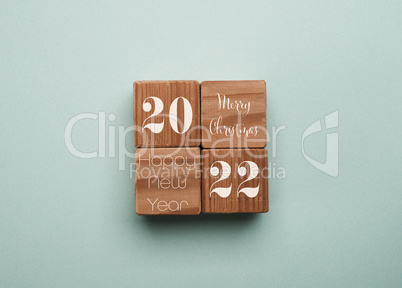 Four wooden cubes with the text Merry Christmas, Happy New Year