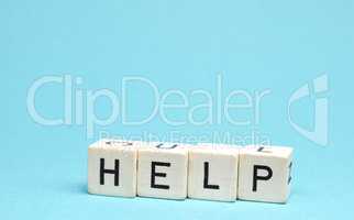 Wooden blocks with the word help on a blue background