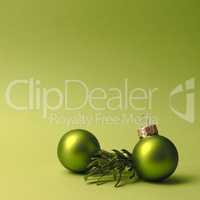 Green vintage Christmas baubles on a green background