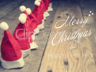Many hats of Santa on a rustic wooden table, Merry Christmas