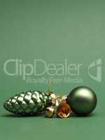 Green Christmas baubles on a green background with space for you