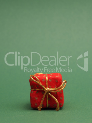Red gift box on a green background with space for your text or i