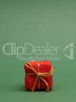 Red gift box on a green background with space for your text or i