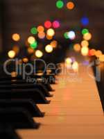 Piano keyboard with fairy lights and colorful Christmas lights