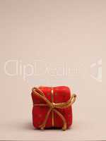 Red gift box on a bright background with space for your text or