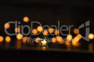 Small wooden star shape with blurred lights