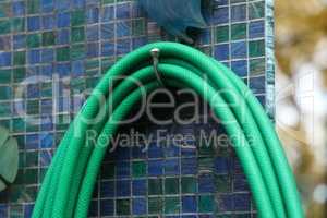 Green hose for watering plants in the garden