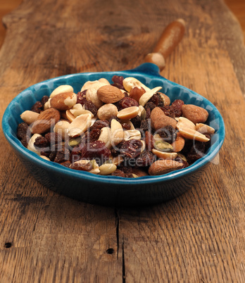 Nut mixture with raisins in a blue bowl