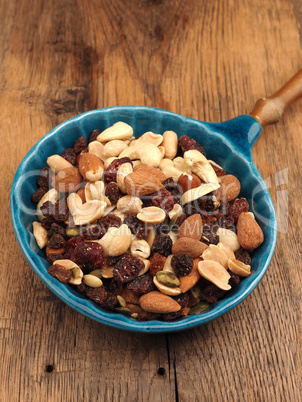 Organic nut mixture with raisins in a blue bowl
