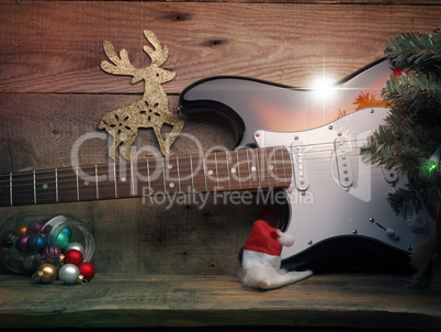 Old used vintage guitar with Christmas lights on a wooden plank
