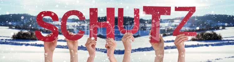 People Hands Holding Word Schutz Means Protection, Snowy Winter Background