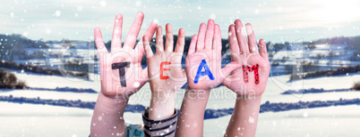 Children Hands Building Word Team, Snowy Winter Background