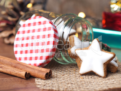 Cinnamon stars in a jar with Christmas decoration on a wooden ta