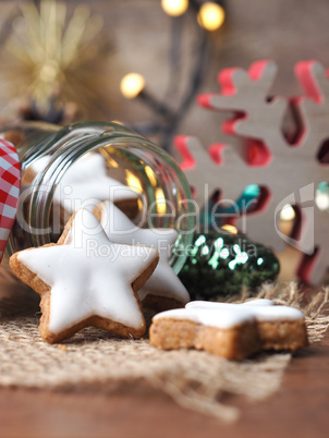 Cinnamon stars in a jar with Christmas decoration on a wooden ta