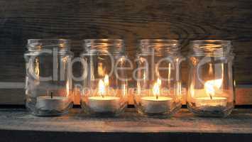Candle burning on a rustic wooden table