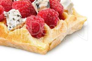 Closeup of french waffles with raspberries and dorblu cheese