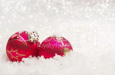 Two Christmas balls in snow