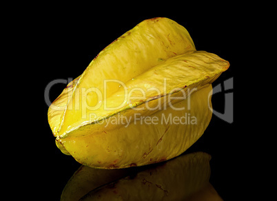 Ripe yellow carom rotated with reflection on black