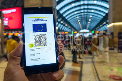 Woman showing on smartphone EU Digital Covid Certificate.