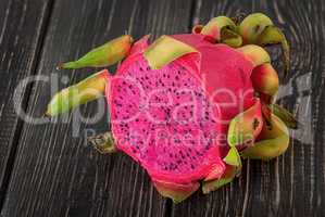 Half dragon fruit on a wooden planks