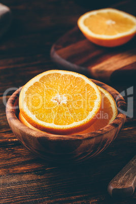 Sliced orange in a wooden bowl