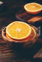 Sliced orange in a wooden bowl